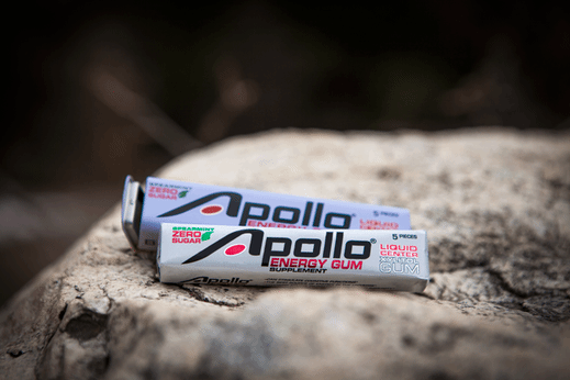 two packs of apollo energy gum on a rock